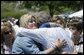 President George W. Bush is embraced by the family of a fallen law enforcement officer, following the President’s address at the annual Peace Officers' Memorial Service at the U.S. Capitol Tuesday, May 15, 2007. White House photo by Joyce Boghosian