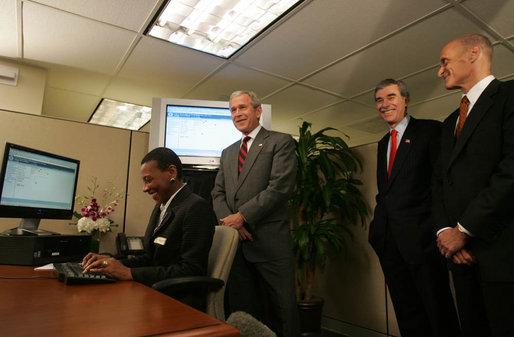 President George W. Bush is joined by Secretary Michael Chertoff, right, of the Department of Homeland Security, and Secretary Carlos Gutierrez of the Department of Commerce, as they look on during a demonstration Wednesday, May 16, 2007, of the Basic Pilot/Employment Eligibility Verification System, a voluntary program managed by U.S. Citizenship and Immigration Services that allows employers to electronically verify the eligibility of newly hired employees. The demonstration, led by Glenda Wooten-Ingram, Director of Human Resources, was held at the Embassy Suites Washington, D.C.-Convention Center, and was followed by a roundtable discussion of the program. White House photo by Joyce Boghosian