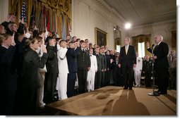 President George W. Bush attends a commissioning ceremony for Joint Reserve Officer Training Corps Thursday, May 17, 2007, in the East Room of the White House, as U.S. Secretary of Defense Robert Gates administers the commissioning oath to the ROTC members. White House photo by Eric Draper