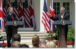 President George W. Bush points emphatically towards Prime Minister Tony Blair in the Rose Garden Thursday, May 17, 2007, as he tells the media, "What I know is the world needs courage. And what I know is this good man is a courageous man."  White House photo by Eric Draper