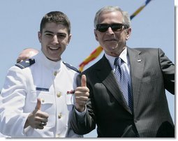 President George W. Bush, wearing the sunglasses of U.S. Coast Guard graduate Steven Matthew Volk, poses with Volk for a thumbs-up photo following the President’s address to the graduates Wednesday, May 23, 2007, at the U.S. Coast Guard Academy commencement in New London, Conn. White House photo by Joyce N. Boghosian