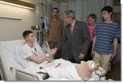 President George W. Bush shakes the hand of Cpl. Ryan T. Dion of Manchester, Conn., after awarding him a Purple Heart Thursday, May 25, 2007, during a visit to the National Naval Medical Center in Bethesda, Md., where the Marine is recovering from wounds received in Operation Iraqi Freedom. With them are Cpl. Dion's parents, Thomas and Patricia Dion, and brother, Justin. White House photo by Joyce N. Boghosian