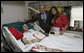 President George W. Bush stands with PFC. Arturo E. Weber and his cousin, Lisa, after awarding the Marine with a Purple Heart during a visit Friday, May 25, 2007, to the National Naval Medical Center in Bethesda, Md., where he is recovering from wounds received in Operation Iraqi Freedom. White House photo by Joyce N. Boghosian