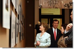 Joined by Dr. R Gerald Turner, President of Southern Methodist University, and Myra Walker, guest curator, Mrs. Laura Bush looks at magazine covers that feature Balenciaga's dresses during a tour of The Balenciaga exhibition at the Meadows Museum Saturday, May 26, 2007, in Dallas. White House photo by Shealah Craighead