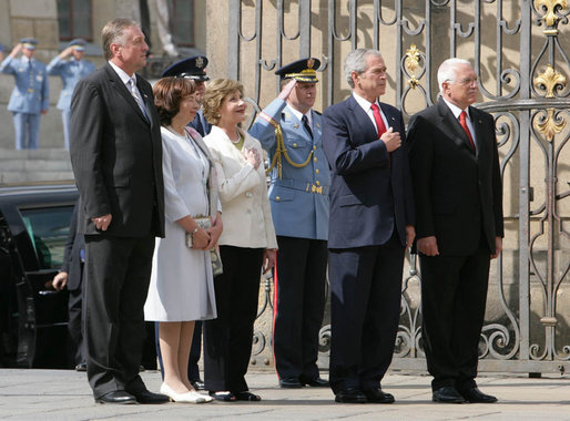 President George W. Bush and Mrs. Laura Bush listen to the U.S. National Anthem on their arrival to Prague Castle in the Czech Republic Tuesday, June 5, 2007, welcomed by Czech President Vaclav Klaus, right; his wife, Livia Klausova and Czech Prime Minister Mirek Topolanek, left. White House photo by Chris Greenberg