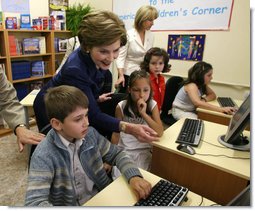 Mrs. Laura Bush joins youngsters at the opening of the American Children's Corner at Sofia City Library Monday, June 11, 2007, in Sofia. Mrs. Bush said, "The books in this American Corner tell the story of the United States, describing my country's history, culture and diverse society. In these books, children in Sofia can discover literature that children in the United States enjoy."  White House photo by Shealah Craighead