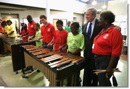 President George W. Bush listens as kids at the Boys and Girls Club of South Central Kansas-21st Street Club play "Hail to the Chief" during his visit Friday, June 15, 2007, to Wichita. White House photo by Eric Draper