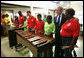 President George W. Bush listens as kids at the Boys and Girls Club of South Central Kansas-21st Street Club play "Hail to the Chief" during his visit Friday, June 15, 2007, to Wichita. White House photo by Eric Draper