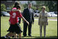 Mrs. Laura Bush and Mike Gottfried, CEO of Team Focus, watch Team Focus participants run a relay race Thursday, June 21, 2007, in Mobile, Ala., during a visit to Team Focus’ National Leadership Camp, as part of Helping America’s Youth initiative. Team Focus is a faith-based, nonprofit organization devoted to improving the lives of young men, ages 10-18, without fathers in their lives. White House photo by Shealah Craighead