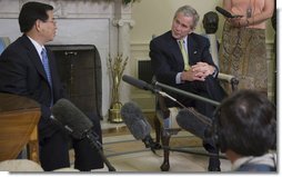 President George W. Bush listens to remarks by President Nguyen Minh Triet of Vietnam during his visit Friday, June 22, 2007, to the Oval Office. ".I would like to take this opportunity to send a message to American people," said President Triet, during the meeting. ".If both peoples both want peace, friendship and solidarity, then we should join hands and march toward the future." White House photo by Eric Draper