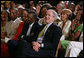 President George W. Bush, entrepreneur Bob Johnson, left, and invited guests respond to entertainers Friday, June 22, 2007 in the East Room of the White House, in celebration of Black Music Month. White House photo by Chris Greenberg