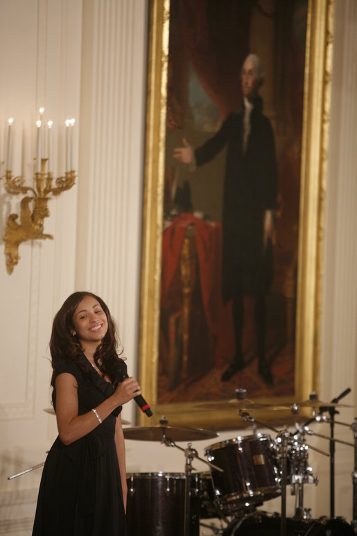 Singer Karina Pasian stands before a portrait of George Washington as she performs for President George W. Bush and guests Friday, June 22, 2007 in the East Room of the White House, in celebration of Black Music Month. White House photo by Debra Gulbas