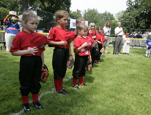 Members of the Luray, Virginia Red Wings hold their caps over their hearts during the playing of the national anthem Wednesday, June 27, 2007, prior to the start of the 2007 White House Tee Ball opener against the Bobcats of Cumberland, Maryland. White House photo by Eric Draper