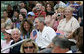 President George W. Bush joins honorary tee ball commissioner and two-time Olympic gold medalist Michele Smith on the South Lawn sidelines of the 2007 White House Tee Ball season opener Wednesday, June 27, 2007. The game matched the Red Wings of Luray, Virginia against the Bobcats of Cumberland, Maryland. White House photo by Eric Draper