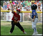 It's safe at first for a Cumberland Bobcat as the Red Wings' first baseman returns the ball to the catcher Wednesday, June 27, 2007, during the first game of the 2007 White House Tee Ball season on the South Lawn. The game pitted the Luray, Virginia team against the Cumberland, Maryland kids, and marked the seventh year of the President's White House Tee Ball Initiative. White House photo by Eric Draper