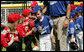 High-fives abound between the Luray, Virginia Red Wings and the Cumberland, Maryland Bobcats after the opening game of the 2007 White House Tee Ball season Wednesday, June 27, 2007, on the South Lawn. White House photo by Eric Draper