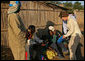 Mrs. Laura Bush hands out insecticide-treated malaria nets during a visit to a malaria spraying site Wednesday, June 27, 2007, in Mozal, Mozambique. In 2005, President Bush created the President's Malaria Initiative, an interagency effort, with a budget of $30 million. Since then the President has commited an additional $1.2 billion to the program. White House photo by Shealah Craighead