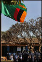 Mrs. Laura Bush and Ms. Jenna Bush listen to a song performed by students during their visit to the Regiment Basic School with First Lady Mrs. Maureen Mwanawasa and her daughter Chipo Mwanawasa Thursday, June 28, 2007, in Lusaka, Zambia. The school is the site of the first U.S.-funded PlayPump water system. The pump provides a sustainable source of clean drinking water for the community. White House photo by Lynden Steele