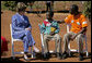 Mrs. Laura Bush talks with Raphael Lungo, 10, during a discussion with caregivers and beneficiaries of the Mututa Memorial Center Thursday, June 28, 2007 in Lusaka, Zambia. The center provides many humanitarian services including home-based care for people living with HIV/AIDS, care for orphans and promotes abstinence and faith for youth. White House photo by Shealah Craighead