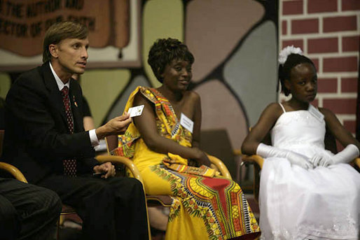 U.S. Global AIDS Coordinator Ambassador Mark Dybul holds up a SMART card during a roundtable discussion with Mrs. Laura Bush, Mrs. Maureen Mwanawasa, doctors, patients and officials about HIV/AIDS at Chreso Ministries, which provides counseling, testing and support for people living with HIV/AIDS, Thursday, June 28, 2007, in Lusaka, Zambia. The card contains the medical history of its holder and facilitates accurate and efficient health care for patients. White House photo by Shealah Craighead