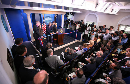 President George W. Bush and Mrs. Laura Bush participate in the ribbon-cutting ceremony to officially open the newly renovated James S. Brady Press Briefing Room Wednesday morning, July 11, 2007, at the White House. White House photo by Eric Draper