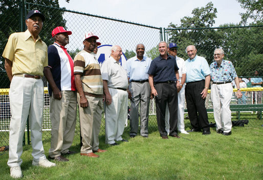 President George W. Bush, joined Baseball Hall of Fame player and honorary tee ball commissioner Frank Robinson, center, along with Hall of Fame manager Tommy Lasorda and fellow legendary players, retire the number of baseball great Jackie Robinson at the White House Tee Ball Game Sunday, July 15, 2007, on the South Lawn of the White House. All players wore the number 42 to celebrate the legacy of Jackie Robinson. More about Tee Ball on the South Lawn. White House photo by Chris Greenberg