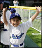 An excited member of the Wrigley Little League Dodgers of Los Angeles shows off his Presidential autographed baseball following their game against the Inner City Little League of Brooklyn, N.Y., Sunday, July 15, 2007, at the White House Tee Ball Game celebrating the legacy of Jackie Robinson on the South Lawn of the White House. Brooklyn and Los Angeles represent the two home cities of Robinson's team. More about Tee Ball on the South Lawn. White House photo by Joyce N. Boghosian