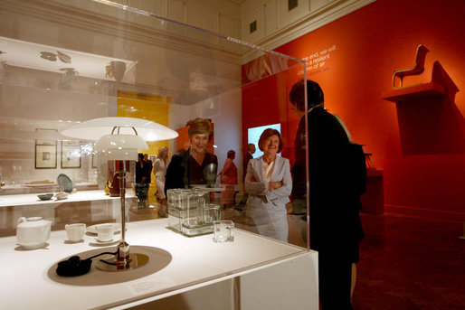 Visiting the Corcoran Gallery of Art, Mrs. Laura Bush and Mrs. Maria Kaczynska, First Lady of Poland, look at Poul Henningsen's table lamp, “PH", during a tour of the exhibit Modernism: Designing a New World, 1914-1939, Monday, July 16, 2007, in Washington, D.C. They are led by Director and President Paul Greenhalgh and Administrative Design Chair Catherine Armour. White House photo by Shealah Craighead