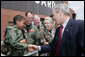 President George W. Bush introduces himself to a young child Thursday, July 19, 2007, at the Tennessee Air National Guard base in Nashville, Tenn., prior to his departure back to Washington, D.C., following a visit to the Nashville Bun Company and a speech at the Gaylord Opryland Resort and Convention Center. White House photo by Chris Greenberg