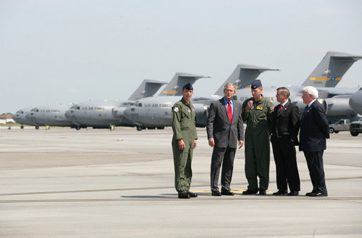 President George W. Bush talks with Colonel Mark Bauknight, acting Commander of the 315th Airlift Wing, left, and Colonel John “Red” Millander, USAF Commander of the 437th Airlift Wing, joined by Senator Lindsey Graham and Congressman Henry Brown, left, prior to observing cargo loading operations aboard a C-17 aircraft Tuesday, July 24, 2007, during a visit to Charleston AFB in Charleston, S.C. White House photo by Eric Draper