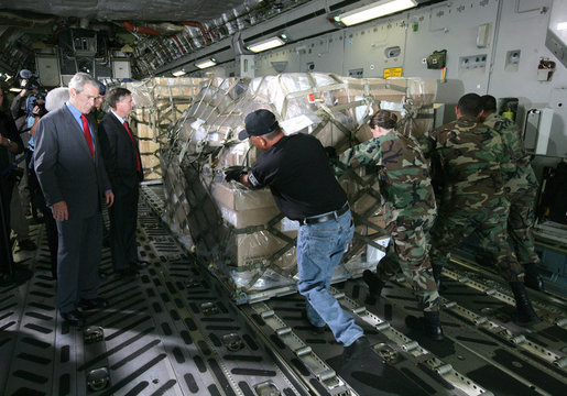 President George W. Bush, joined by South Carolina Senator Lindsey Graham, watches as USAF military personnel conduct cargo loading operations aboard a C-17 aircraft Tuesday, July 24, 2007, during a visit to Charleston AFB in Charleston, S.C. White House photo by Eric Draper