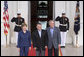 President George W. Bush and Mrs. Laura Bush welcome Jordan's King Abdullah II to the White House Tuesday evening, July 24, 2007, for a social dinner. White House photo by Shealah Craighead