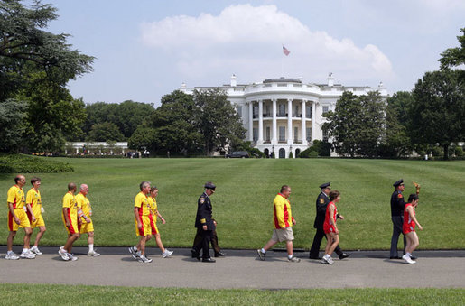 Law enforcement runners and supporters walk with Special Olympic athletes on the South Lawn after attending a Special Olympics Global Law Enforcement Torch Run Ceremony Thursday, July 26, 2007, in the Rose Garden. White House photo by David Bohrer