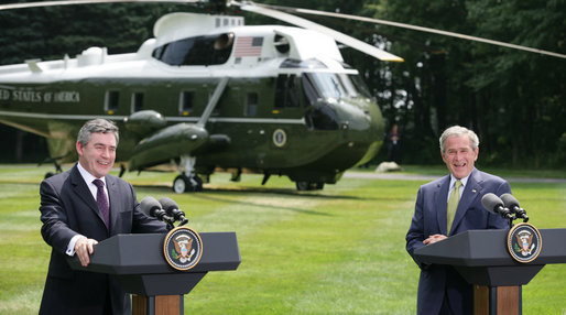 President George W. Bush and British Prime Minister Gordon Brown laugh during their joint press availability Monday, July 30, 2007, at Camp David near Thurmont, Md. White House photo by Eric Draper