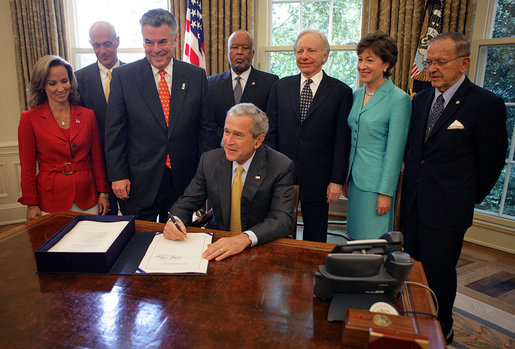 President George W. Bush signs into law H.R. 1, Implementing Recommendations of the 9/11 Commission Act of 2007, Friday, August 3, 2007, in the Oval Office. White House photo by Eric Draper