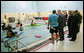 President George W. Bush speaks with Joe Mornini, left, founder of Team River Runner, during the President’s visit Monday, Aug. 13, 2007 to the Washington, D.C. Veterans Affairs Medical Center indoor pool, where recuperating wounded veterans use kayaks to learn and increase their mobile skills. Team River Runner is an all-volunteer organization established in 2004 by kayakers in the Washington area that uses recreation rehabilitation through aquatic therapy activities. White House photo by Chris Greenberg