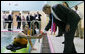 President George W. Bush meets wounded veteran Peter J. Rooney III of Cummington, Mass., a participant in the Team River Runner aquatic therapy program, during the President’s visit Monday, Aug. 13, 2007 to the Washington, D.C. Veterans Affairs Medical Center indoor pool, where recuperating wounded veterans use kayaks to learn and increase their mobile skills. Team River Runner is an all-volunteer organization established in 2004 by kayakers in the Washington area that uses recreation rehabilitation through aquatic therapy activities. White House photo by Chris Greenberg