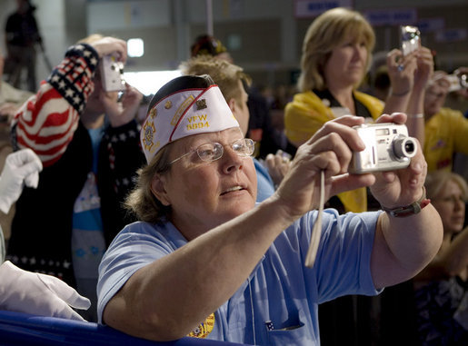 Audience members take photos of President George W. Bush, as he delivers his remarks Wednesday, Aug. 22, 2007, to the Veterans of Foreign Wars National Convention in Kansas City, Mo. White House photo by Chris Greenberg