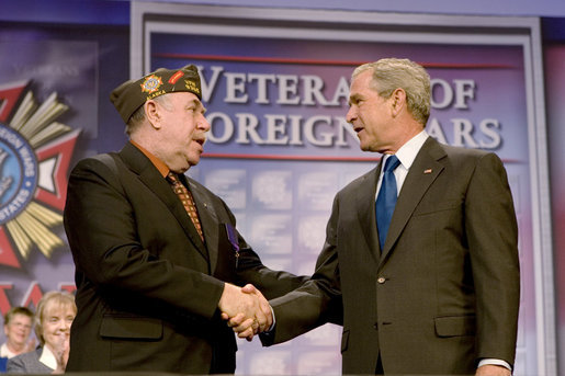 President George W. Bush shakes hands with Veterans of Foreign Wars National Commander Gary Kurpius following the President's address Wednesday, Aug. 22, 2007, to the Veterans of Foreign Wars National Convention in Kansas City, Mo. White House photo by Chris Greenberg