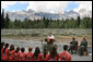 Mrs. Laura Bush speaks to Junior Ranger participants during her visit to Grand Teton National Park Aug. 27, 2007, in Moose, Wyo. "Children here can go back to the prehistoric era at Fossil Butte National Monument, where the remains of fish and insects, snails, turtles, birds, bats and plants are preserved in 50-million-year-old layers of rock," said Mrs. Bush in her address. "Young people can discover the stories of their ancestors, the American pioneers, who migrated west along the Oregon Trail at the Fort Laramie National Area." White House photo by Shealah Craighead