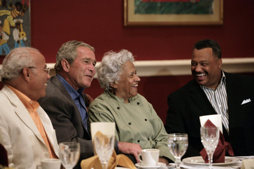 President George W. Bush shares a moment with restaurant owner Leah Chase, center, and fellow dinner guests Dr. Norman Francis, president of Xavier University of Louisiana, left, and Reverend Fred Luter, right, during a dinner with Louisiana cultural and community leaders Tuesday evening, Aug. 28, 2007, at Dooky Chase's restaurant in New Orleans. President Bush and Mrs. Laura Bush are visiting New Orleans and the Gulf Coast region on the second anniversay of Hurricane Katrina. White House photo by Shealah Craighead