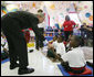 President George W. Bush reaches down to greet a student at the Dr. Martin Luther King Jr. Charter School for Science and Technology Wednesday, Aug. 29, 2007, in New Orleans, during his visit to New Orleans and the Gulf Coast region on the second anniversary of Hurricane Katrina. White House photo by Shealah Craighead