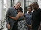 President George W. Bush is embraced by homeowner Gen White as members of her family look on, Wednesday, Aug. 29, 2007, following the President's visit to her new home in New Orleans. White House photo by Shealah Craighead