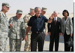 President George W. Bush waves after arriving at Al Asad Airbase, Al Anbar Province, Iraq, Monday, September 3, 2007. The greeting party from left are Lieutenant General Raymond Odierno, Commanding General, Multi-National Corps, General David Petraeus, Commander, Multi-National Force Iraq, Admiral William Fallon, Commander US Central Command, General Peter Pace, Chairman of the Joint Chiefs of Staff, Secretary of Defense Robert Gates and Secretary State Condoleezza Rice. White House photo by Eric Draper