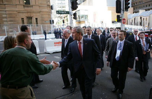 President George W. Bush shakes hands with an unidentified couple Wednesday, Sept. 5, 2007, as he walks to the InterContinental Hotel in Sydney with Prime Minister John Howard of Australia, following their morning meetings. White House photo by Eric Draper