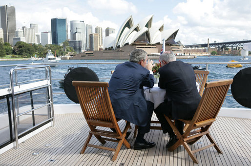 With the Sydney Opera House as a backdrop, President George W. Bush and Prime Minister John Howard of Australia, talk as they tour Sydney Harbour Wednesday, Sept. 5, 2007, aboard the MV AQA. White House photo by Eric Draper