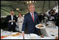 With Australia's Prime Minister John Howard and his wife, Janette Howard, smiling in the background, President George W. Bush kids with members of the media Wednesday, Sept. 5, 2007, during a luncheon with Australian troops on Garden Island in Sydney. White House photo by Chris Greenberg