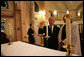 As Reverend Luis León looks on, President George W. Bush lights a candle during a service of prayer and remembrance at St. John's Episcopal Church in Washington, D.C., Tuesday, Sept.11, 2007, marking the sixth anniversary of the Sept. 11, 2001 terrorist attacks on U.S. soil. White House photo by Eric Draper