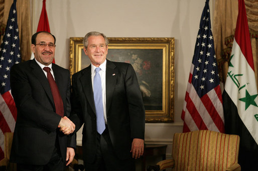 President George W. Bush and Prime Minister Nouri Al-Maliki of Iraq, shake hands after their meeting Tuesday, Sept. 25, 2007, at the Waldorf-Astoria Hotel in New York City. The President told his Iraq counterpart, ".We're with you, Prime Minister. We thank you for the courage of the Iraqi people." White House photo by Eric Draper