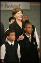 Mrs. Laura Bush stands with students from New York Public School 76 during the President’s statement regarding No Child Left Behind Wednesday, Sept. 26, 2007, in New York. White House photo by Eric Draper